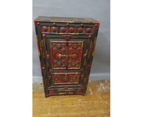 AN ORIENTAL PINE AND POLYCHROME SIDE CABINET, with cupboards and drawer decorated with paterae roundels on moulded base,119cm