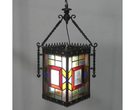 An Arts and Crafts stained glass Lantern, the four panels of lead lined glass mounted in&nbsp;a gothic style pressed metal fr
