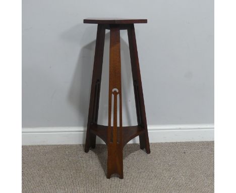 An Arts and Crafts oak Table/Plant Stand, in the style of Liberty &amp; co, with hexagonal top raised on tripod supports with