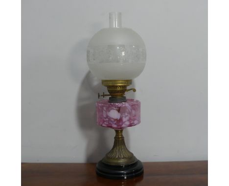 A Victorian cranberry glass oil Lamp, with etched glass shade and stamped 'Made in England', H 56 cm.