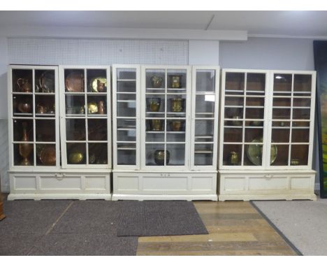 A very large 19th century painted pine glazed Bookcase, with later additions, made up of three sections, all with glazed door