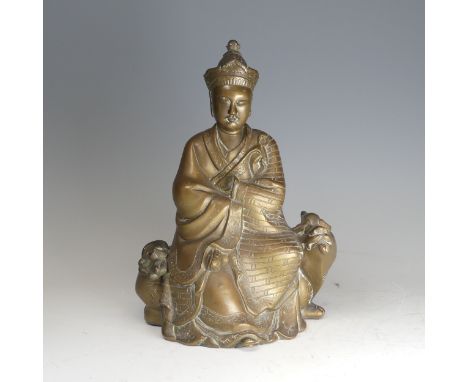 A late 19th century Chinese bronze figure of Quanyin, seated on a Luduan mythical beast, 27cm high.