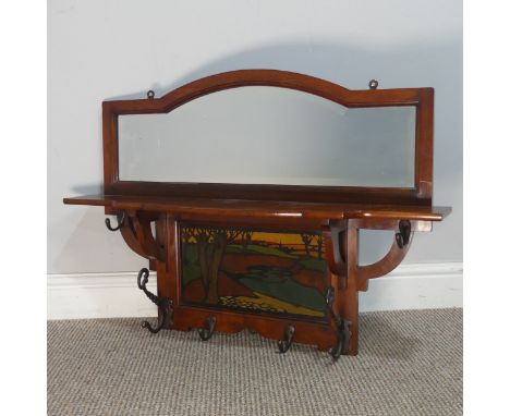 A Shapland and Petter of Barnstaple mahogany Arts and Crafts hall Mirror, the arched mirror over open shelf and inset with a 