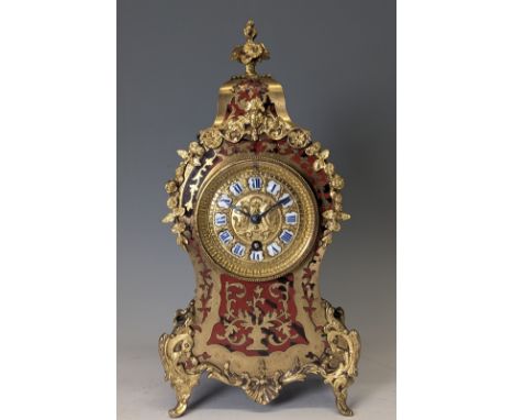 A late 19th century French brass mounted and red tortoiseshell Boulle mantel Clock, the brass-cast dial with twelve enamel Ro
