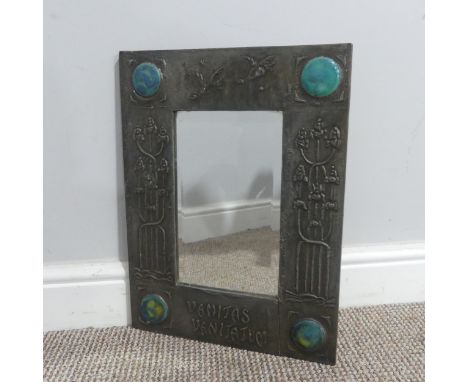 An Arts and Crafts pewter Mirror, the frame embossed with stylised flowers and birds, inscribed 'Vanitas Vanitatum' and each 