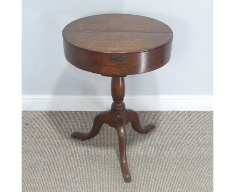 An early 20th century oak drum tripod Table, the hinged circular top raised on turned column, upon cabriole legs and pad feet