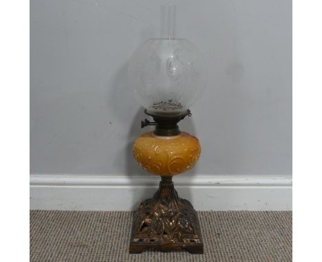 An Art Nouveau Oil Lamp, with orange glass reservoir decorated with stylised flowers, complete with floral etched shade and f