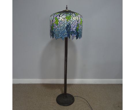 A Tiffany &amp; Co style standard Lamp, the stained and lead lined glass shade raised on metal column and base, H 155 cm.