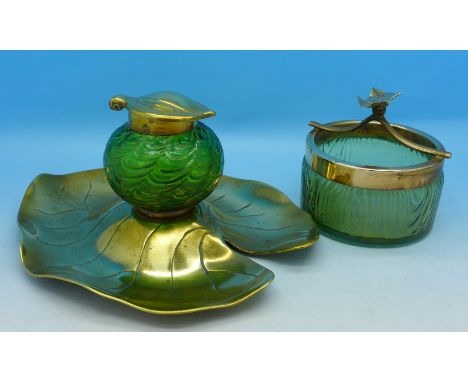 An Art Nouveau brass and glass inkwell (with removable inkwell) and an opalescent glass and copper ashtray