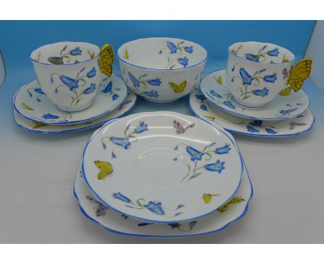 Royal Albert teaware with butterfly handles and decoration, nine pieces in total, (two cups, three saucers, three side plates