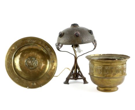 Art Nouveau brass lamp the hammered finish shade studded with red glass 'rocks' , height 41 cm, a charger with central monogr