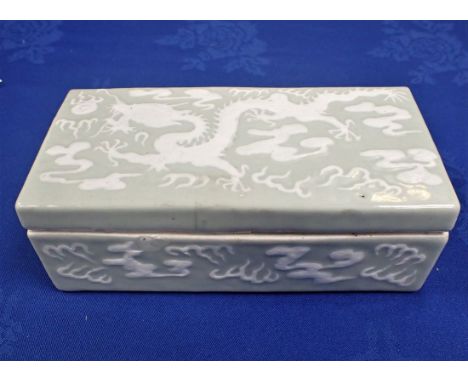 A CHINESE LIDDED CERAMIC BOX with celadon glaze decorated with dragons