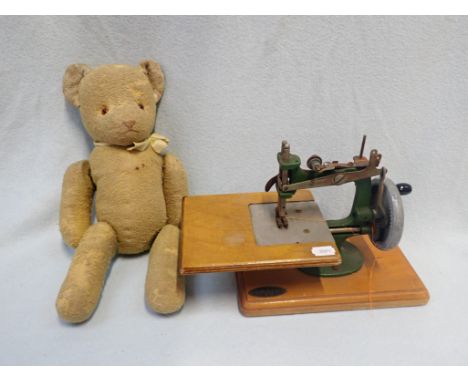 A VINTAGE 'GRAIN' TOY SEWING MACHINE and a unmarked teddy bear