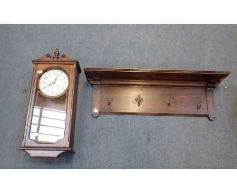 AN EARLY 20TH CENTURY WALL MOUNTED COAT RAIL oak, with moulded edges above four brass hangers, 78cm wide, together with a Rhy