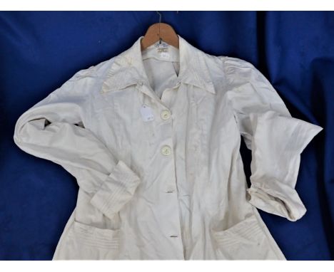 A VINTAGE WHITE COTTON LADIES' COAT or overall, by John Lewis, and a similar apron