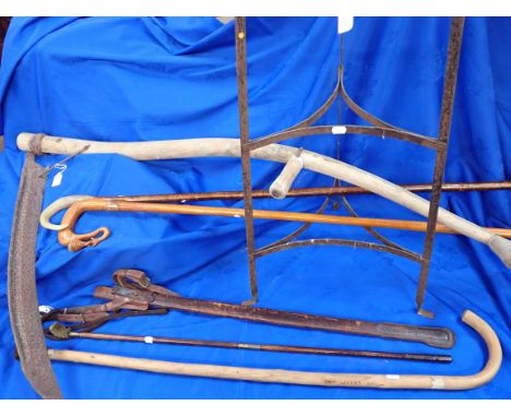 A SCYTHE, A THREE-TIER IRON POT STAND a sword scabbard, gun cleaning rod and other items