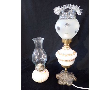 A LATE VICTORIAN OIL LAMP with frosted shade and painted reservoir, 54cm high, together with another oil lamp (2)