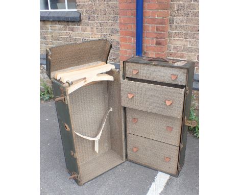AN EARLY 20TH CENTURY TRAVELLING WARDROBE TRUNK, WITH LABELS fitted with drawers and hangers 100cm high