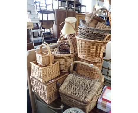 A COLLECTION OF WICKER BASKETS including a hamper, handbaskets, and bottle carriers