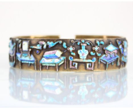 A Chinese enamel and gilt metal bangle, the wide cuff style bangle decorated in naively enamelled symbols depicting vase, cha