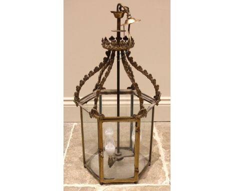A brass hanging hall lantern, late 19th/early 20th century, of hexagonal form, the circular boss with a cast stiff leaf galle