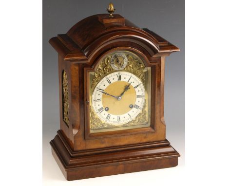 A German walnut cased bracket clock, by Mathias Bauerle, late 19th/early 20th century, the arched case with a brass acorn sha
