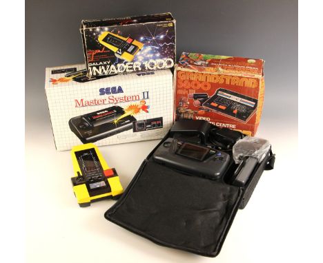 A vintage CGL ‘Galaxy Invader 1000’ handheld computer space battle game, circa 1980, in original box; with a Sega Master Syst