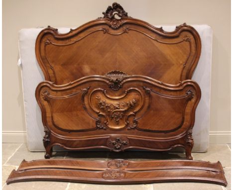 A French Louis XV style kingwood and rosewood bed, late 19th/early 20th century, the serpentine headboard with a carved 'C' s