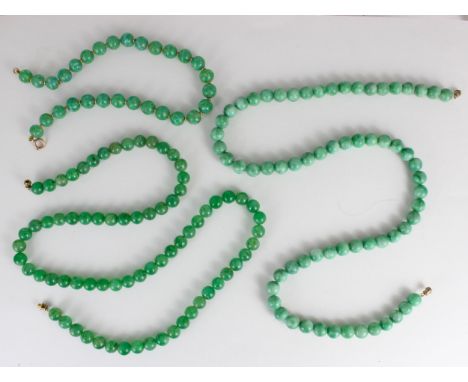 A string of hydrogrossular garnet beads, the ‘jade’ coloured beads with screw barrel fastening, 76cm long, with a dyed quartz
