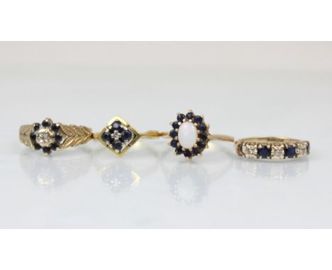 A group of four dress rings, including an 18ct untested sapphire and diamond stylised cluster ring, ring size K, a 9ct opal a
