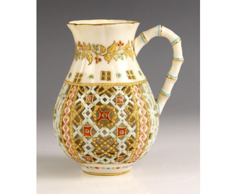 A Worcester style porcelain ‘Japanesque’ jug, late 19th century, the double walled reticulated body with faux bamboo handle a