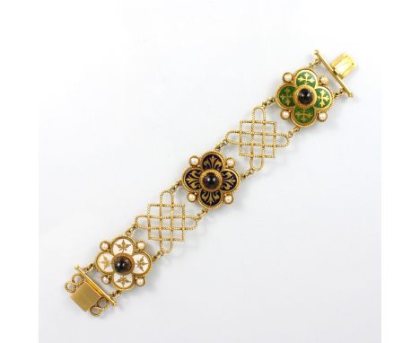 A 19th century enamel and untested garnet set bracelet, the three quatrefoil shaped panels with green, blue and white enamell