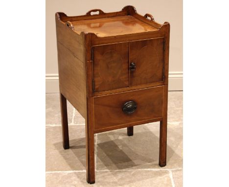 A George III  mahogany tray top bedside cupboard, the tray top with hand apertures to three sides, over a pair of cupboard do
