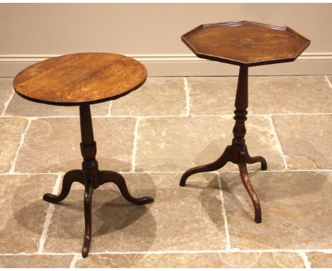A George III oak tripod table, the octagonal top with a moulded rim upon a slender baluster column and three down swept suppo