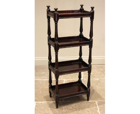 A 19th century mahogany four tier whatnot, the galleried tiers supported upon turned baluster uprights and peg feet, below bu
