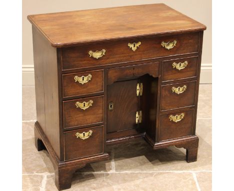 A George II mahogany kneehole desk, the rectangular moulded top with rounded front corners over a cock beaded frieze drawer, 