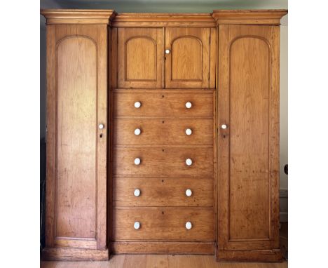 A Victorian pine inverted breakfront compactum wardrobe, the moulded cornice over a pair of recessed cupboard doors and five 