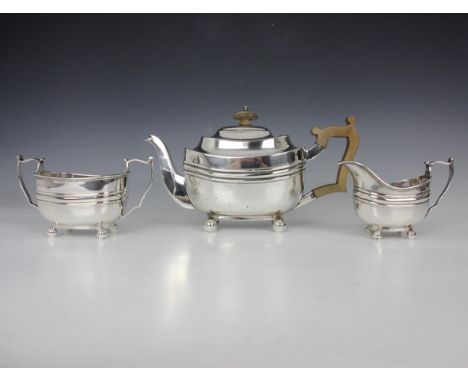 A Victorian three piece silver tea service, Thomas Bradbury &amp; Sons, London 1897, comprising sugar bowl, teapot and milk j