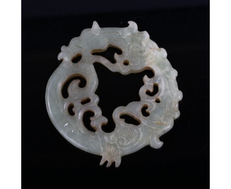 A large Chinese carved and pierced jade sea dragon disc, diameter 9cm 
