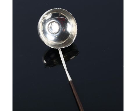 A George II silver toddy ladle, with whale bone handle and inset coin dated 1758 