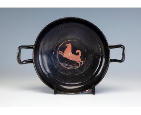 Attic kyklix with red figures, 5th century BC.Polychrome pottery.It has a hair but is in one piece.Measurements: 6 x 26 x 19 