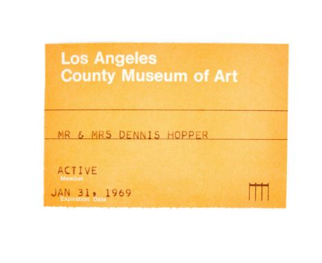 An orange Los Angeles County Museum of Art (LACMA) membership card belonging to Dennis Hopper. The card reads: "Mr &amp; Mrs 