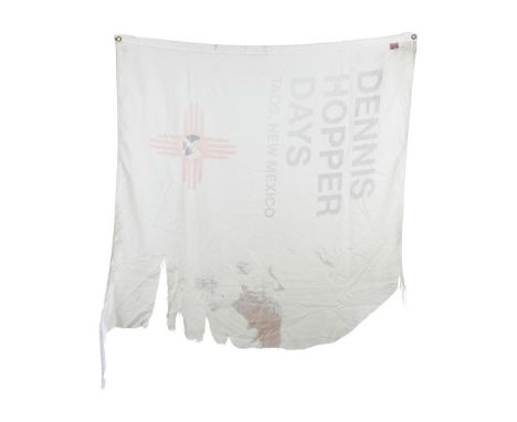 A cream-colored nylon flag with the words "DENNIS / HOPPER / DAYS / TAOS, NEW MEXICO" silk-screened onto the fabric above the