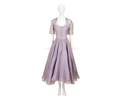 A lavender organdy cocktail dress worn by Grace Kelly in her Golden Globe-winning and Oscar-nominated role as the prim "Linda