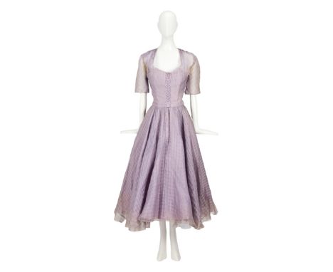 A lavender organdy cocktail dress worn by Grace Kelly in her Golden Globe-winning and Oscar-nominated role as the prim "Linda