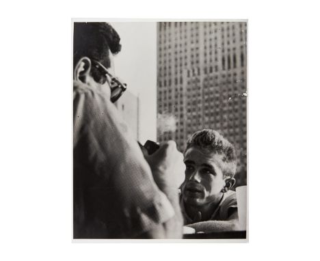 A rare black and white original unpublished photograph of James Dean, circa 1954, that was taken and signed by Roy Schatt. In