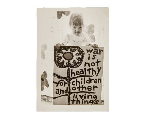 A black and white photograph taken by Dennis Hopper, circa mid-1960s, of his daughter Marin Hopper&nbsp;holding a protest sig