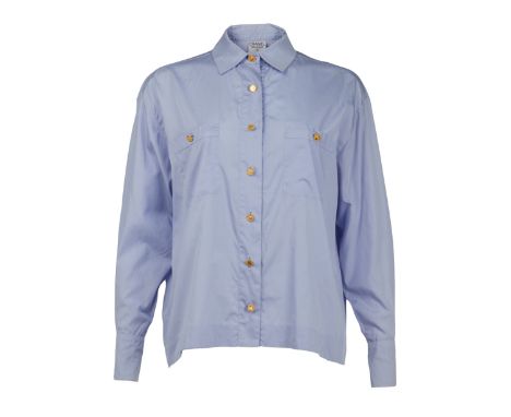 A pale blue cotton blouse with embossed gold tone buttons, owned by Elizabeth Taylor. The blouse has a Chanel Boutique label 