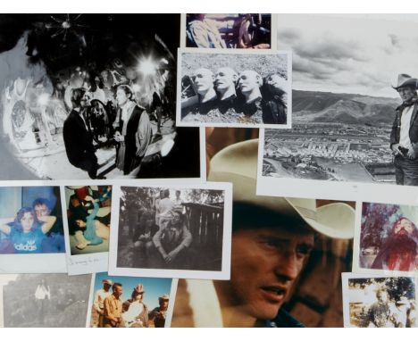 A group of more than a dozen photographs of Dennis Hopper and costars and crewmembers taken on film sets. Included is a black