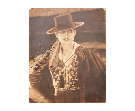 A vintage photograph of Douglas Fairbanks, inscribed "Very Sincerely," signed, and dated 1925 by him.Please note: The photogr